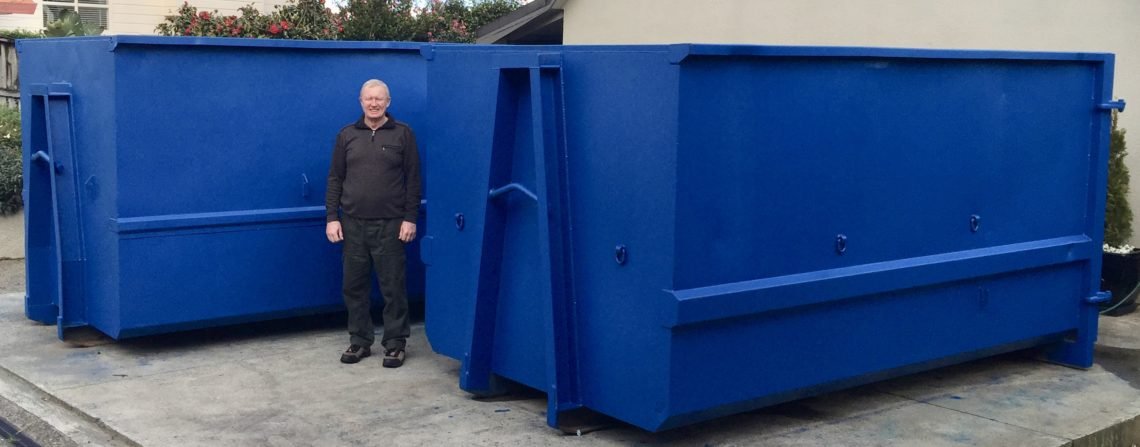 Man in front of a 15 metre rubbish bin