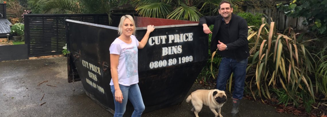 Family in front of a cut price bins bin