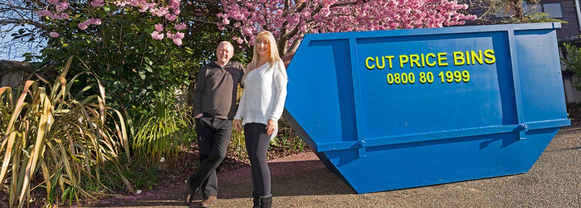 Owners of cut price bins in front of a bin